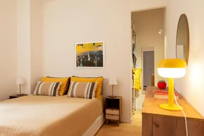a bedroom with a bed and a yellow lamp at Casa Porta Metronia in Rome