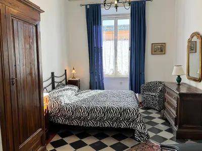 a bedroom with a bed and a dresser and a window at Casa Angeli in Rome