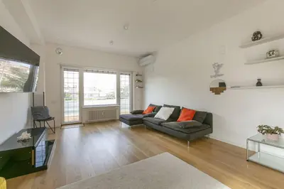 a living room with a couch and a table at Luxe Vatican Penthouse in Rome