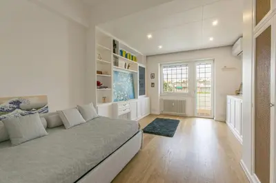 a living room with a large bed and a window at Luxe Vatican Penthouse in Rome
