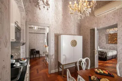 a living room with a table and a dining room at The Inn at the Spanish Steps Luxury Collection - Suite Condotti in Rome