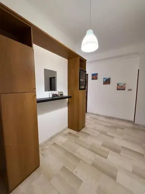 an empty room with a kitchen and a counter at Domus Romae Caffarella in Rome