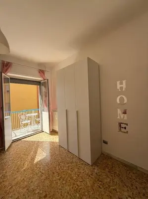 an empty room with a white cabinet and a door at Domus Romae Caffarella in Rome