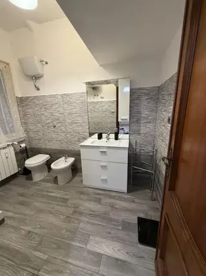 a bathroom with a sink and a toilet and a shower at Domus Romae Caffarella in Rome