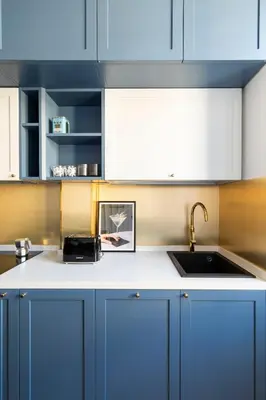 a kitchen with blue cabinets and a sink at YCH-Charming home near San Giovanni in Rome
