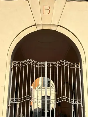 a building with a gate in front of a building at YCH-Charming home near San Giovanni in Rome