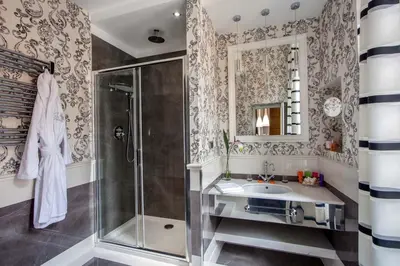 a bathroom with a shower and a sink and a mirror at The Inn at the Spanish Steps Luxury Collection - Mario de' Fiori Home in Rome