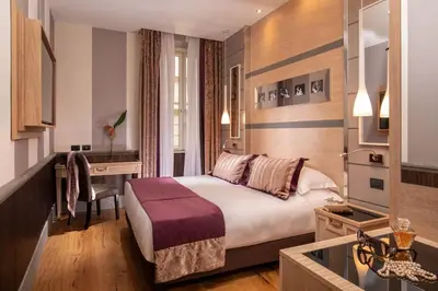 a hotel room with a bed and a desk at The Inn at the Spanish Steps Luxury Collection - Mario de' Fiori Home in Rome