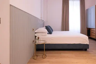 a bedroom with a bed with a iron headboard at Tiburtina 86 Luxury Suites in Rome