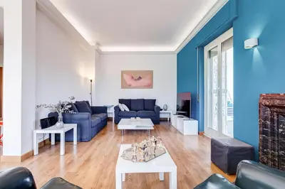a living room with blue walls and a blue couch at Chigi's Terrace in Rome