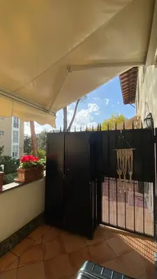 a patio with a black gate and a fence at Gemelli Flower's House in Rome