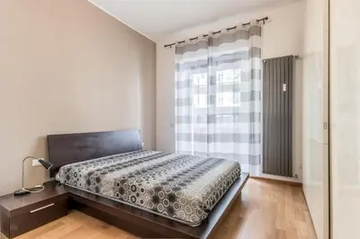 a bedroom with a bed and a large window at Alloggio Chigi in Rome