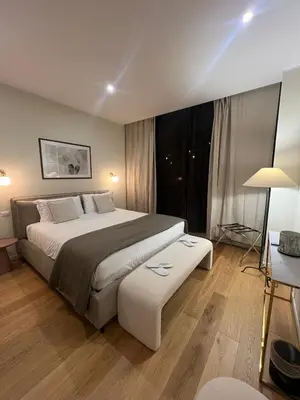 a bedroom with a bed and a large window at Villa Borghese Apartment in Rome
