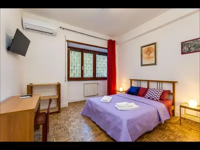 a bedroom with a bed and a desk and a computer at L aROMA ANTICA in Rome