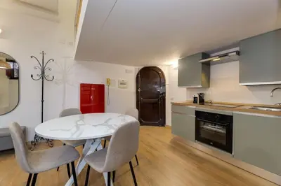 a kitchen with a table and chairs in a room at Trastevere Experience in Rome