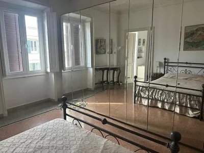 a bedroom with a mirror and a bed and a bed sidx sidx sidx at Nel cuore di Roma in Rome