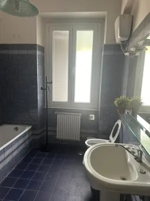 a bathroom with two toilets and a tub and a sink at Nel cuore di Roma in Rome