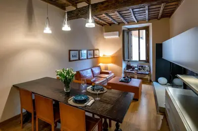 a living room with a table and a couch at Historic center apartment Rome in Rome