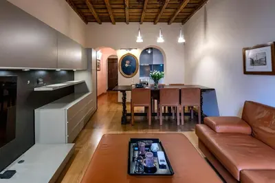 a kitchen and living room with a couch and a table at Historic center apartment Rome in Rome
