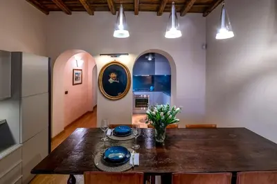 a kitchen and dining room with a wooden table at Historic center apartment Rome in Rome