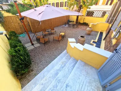 an overhead view of a patio with an umbrella and chairs at Angel's Garden in Rome
