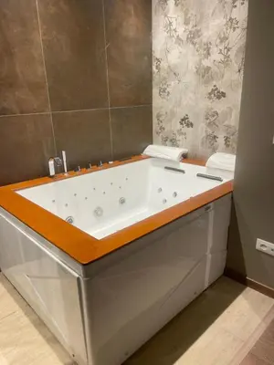 a bathroom with a bath tub with a wooden counter at Stazione Tiburtina Roma in Rome