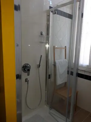 a shower in a bathroom with a glass door at B&B Ondina in Rome