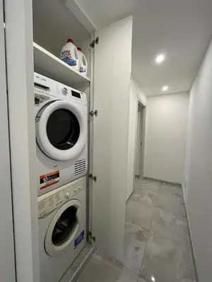 a laundry room with a washer and dryer at Green apartment a Porta Pia in Rome