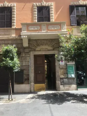 an entrance to a building with a wooden door at Green apartment a Porta Pia in Rome