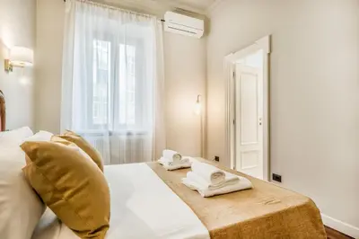 a bedroom with a bed with towels on it at BBHOME Eleganza e comfort unico in San Giovanni district in Rome