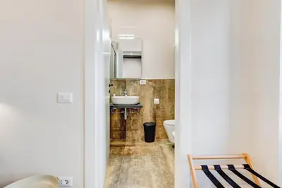 a bathroom with a toilet and a sink at Vivilo Collection - Charme 24 Suites - Close to Via Veneto in Rome