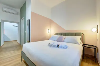 a bedroom with a large bed with two towels on it at Vatican Lante Suite in Rome