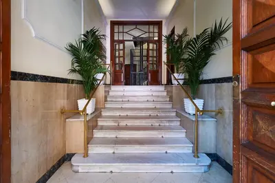 a staircase in a building with potted plants at Vatican Lante Suite in Rome