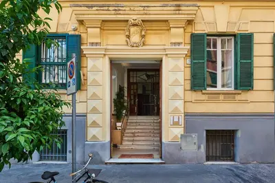 a building with green shuttered windows and a bike parked in front at Vatican Lante Suite in Rome