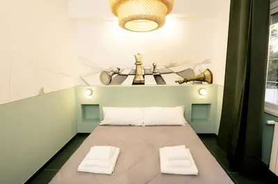 a room with a bed with two white pillows at O Effe Games Vatican in Rome