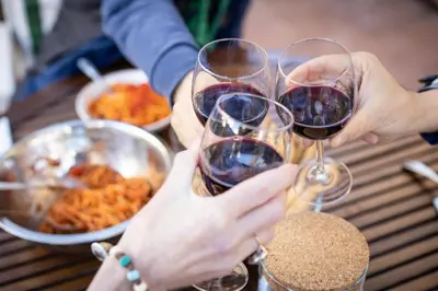 two people holding wine glasses on a table with food at NOBILIA - Roof Garden Penthouse near Navona Square in Rome