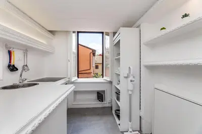 a white room with a table and a microwave at Condotti Loft - city center in Rome
