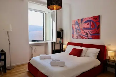 a bedroom with a bed with two towels on it at Casa Frida Arte e Sport tra MAXXI e Olimpico in Rome