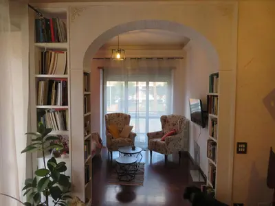 an archway in a living room with two chairs and a table at Maddy House Roma in Rome