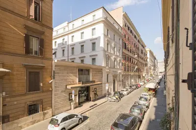 a city street with parked cars and buildings at NINA'S HOUSE - Monti Residences in Rome