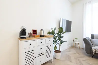 a living room with a table and a couch at NINA'S HOUSE - Monti Residences in Rome