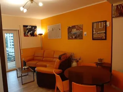 an orange living room with a couch and a table at Casa Oscar in Rome