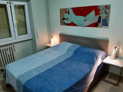 a bed in a bedroom with a blue blanket at Casa Oscar in Rome