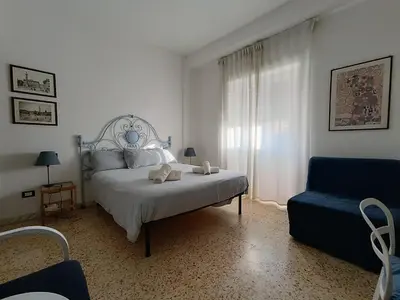 a bedroom with a bed and a blue chair at Bed Bike Breakfast al centro di Roma in Rome