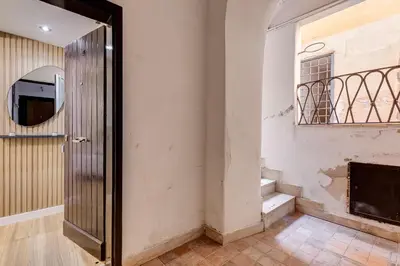 an empty room with a door and a fireplace at Vicolo Sereno Roma in Rome