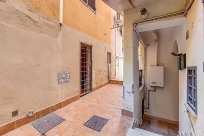 an empty alley with a door in a building at Vicolo Sereno Roma in Rome