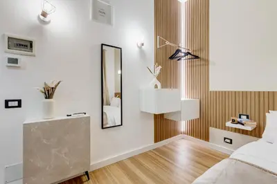 a bedroom with a bed and a mirror at Vicolo Sereno Roma in Rome