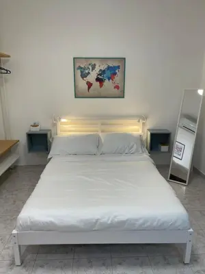 a bed in a room with a white bedvisor at La Casita in Rome