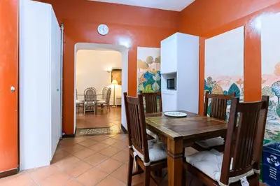 a dining room with a wooden table and chairs at Colosseum Apartment with Terrace by NDP rent in Rome