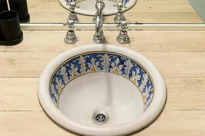 a blue and white sink in a bathroom at Colosseum Apartment with Terrace by NDP rent in Rome